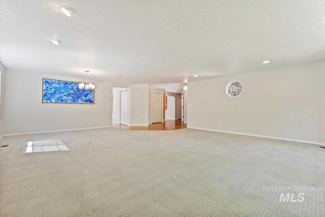 1825 E Seaside Ct, Boise, ID 83706 - unfurnished room featuring a chandelier, light carpet, baseboards, and a textured ceiling
