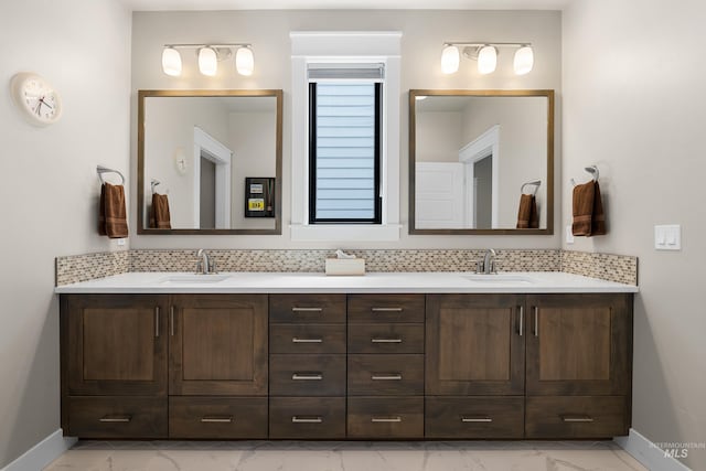 11684 N 23rd Ave, Boise, ID 83714 - full bathroom featuring marble look tiles, double vanity, baseboards, and decorative backsplash
