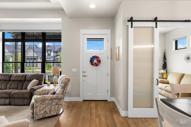 11684 N 23rd Ave, Boise, ID 83714 - foyer entrance with a barn door, wood finished floors, and baseboards