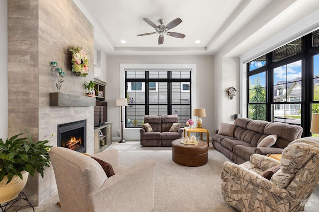 11684 N 23rd Ave, Boise, ID 83714 - living room with a tiled fireplace, a ceiling fan, carpet floors, recessed lighting, and a raised ceiling