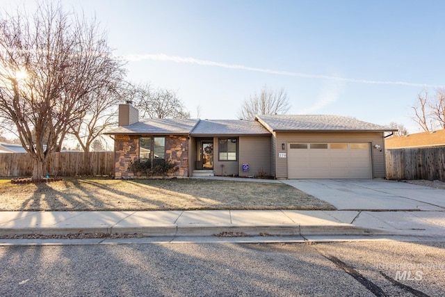 ranch-style home featuring a garage, driveway, a chimney, and fence