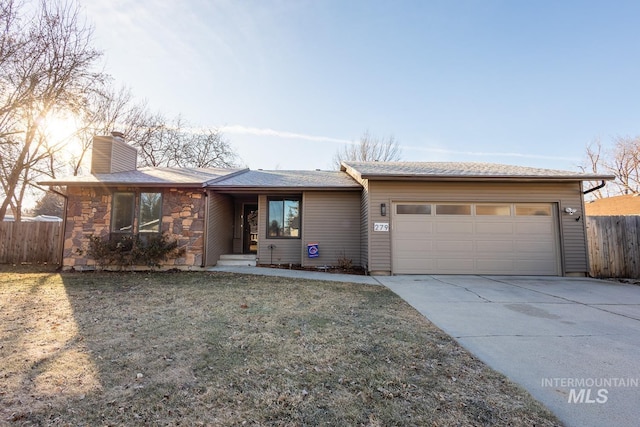 ranch-style house featuring a garage, driveway, a chimney, and fence