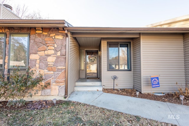 property entrance featuring stone siding