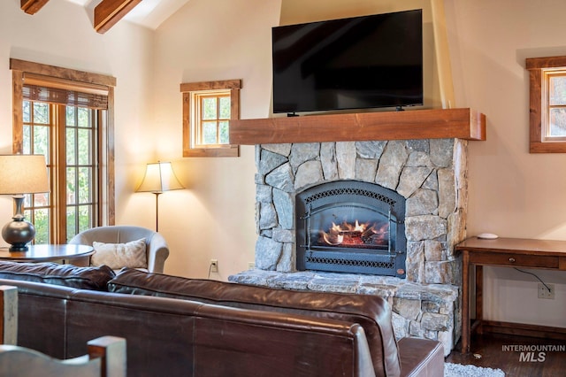 interior space featuring a fireplace, beamed ceiling, and dark hardwood / wood-style floors