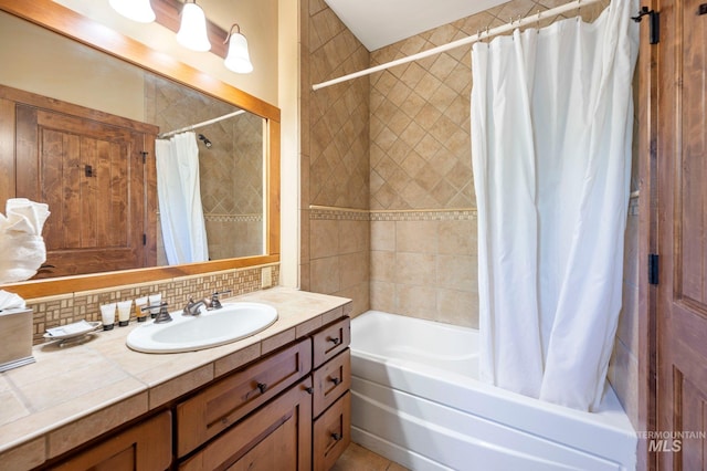 bathroom featuring vanity, shower / bath combo, and tasteful backsplash