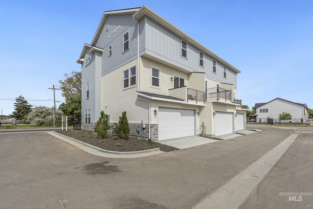 view of front of home with a garage and a balcony