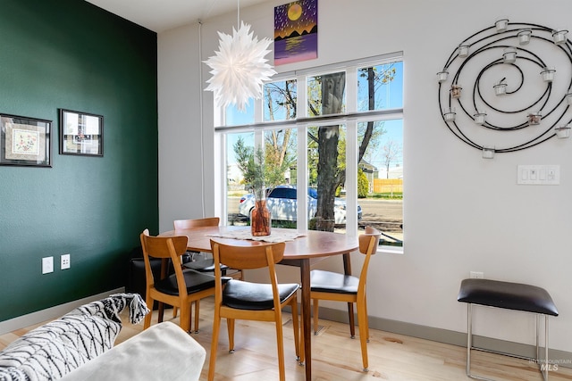 502 S 15th St # 104, Boise, ID 83702 - dining space with baseboards and wood finished floors