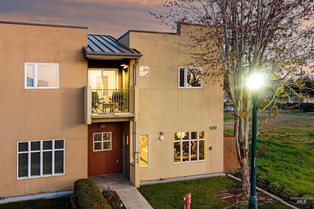 502 S 15th St # 104, Boise, ID 83702 - exterior space with fence, a balcony, a standing seam roof, a front yard, and metal roof