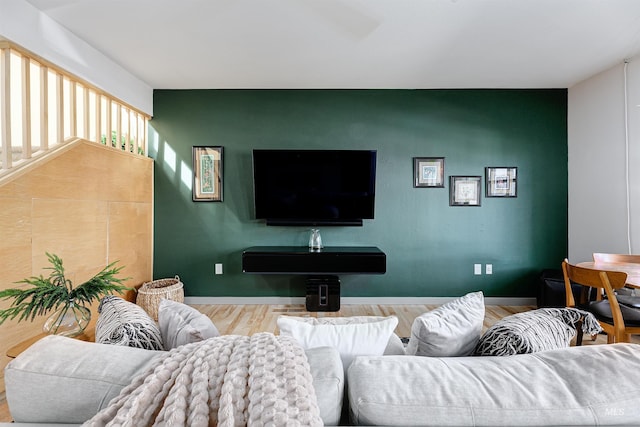 502 S 15th St # 104, Boise, ID 83702 - living area with baseboards, wood finished floors, and an accent wall