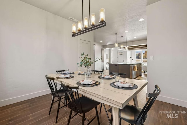 dining space featuring visible vents, baseboards, dark wood finished floors, recessed lighting, and a textured ceiling