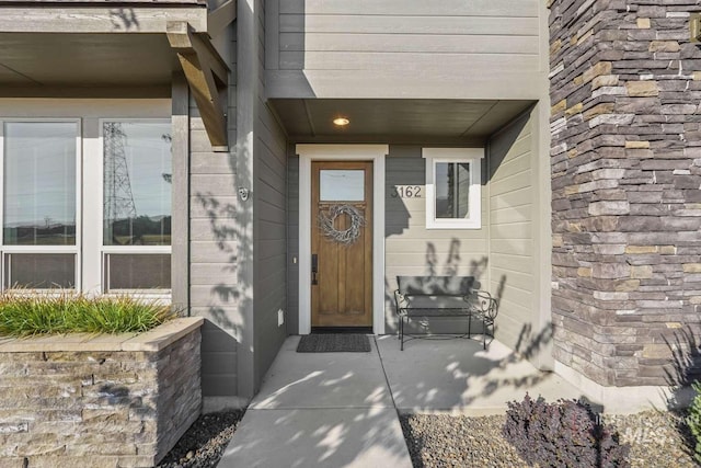 property entrance featuring stone siding