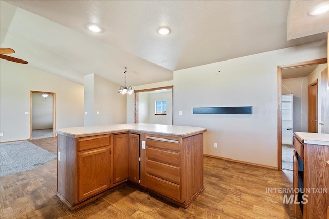 11716 S Emerald Rd, Nampa, ID 83686 - kitchen with light wood-type flooring, lofted ceiling, light countertops, a chandelier, and recessed lighting