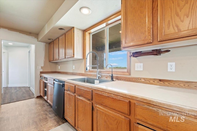11716 S Emerald Rd, Nampa, ID 83686 - kitchen with a sink, dishwasher, light wood-type flooring, light countertops, and brown cabinetry
