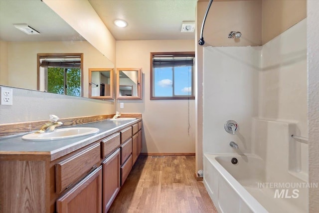 11716 S Emerald Rd, Nampa, ID 83686 - bathroom with double vanity, wood finished floors,  shower combination, and baseboards