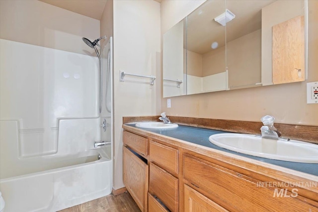 11716 S Emerald Rd, Nampa, ID 83686 - bathroom featuring double vanity, tub / shower combination, and wood finished floors