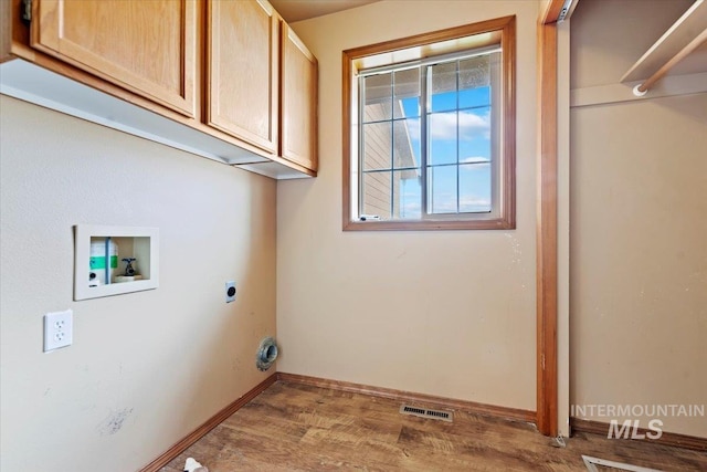 11716 S Emerald Rd, Nampa, ID 83686 - laundry area with cabinet space, washer hookup, electric dryer hookup, wood finished floors, and baseboards