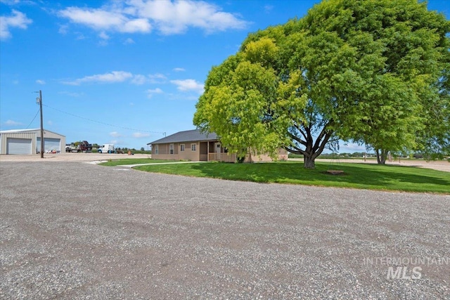 11716 S Emerald Rd, Nampa, ID 83686 - view of front of home with a detached garage and a front lawn