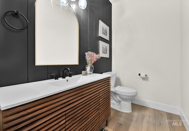 44 Shoemaker Dr, Horseshoe Bend, ID 83629 - half bath with vanity, baseboards, toilet, and wood finished floors
