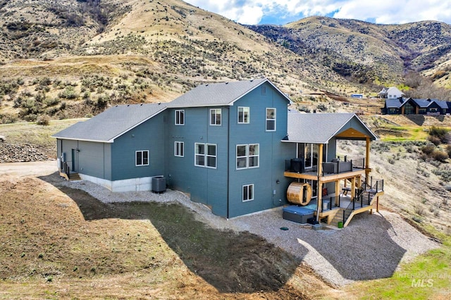 44 Shoemaker Dr, Horseshoe Bend, ID 83629 - back of house featuring a deck with mountain view and central AC