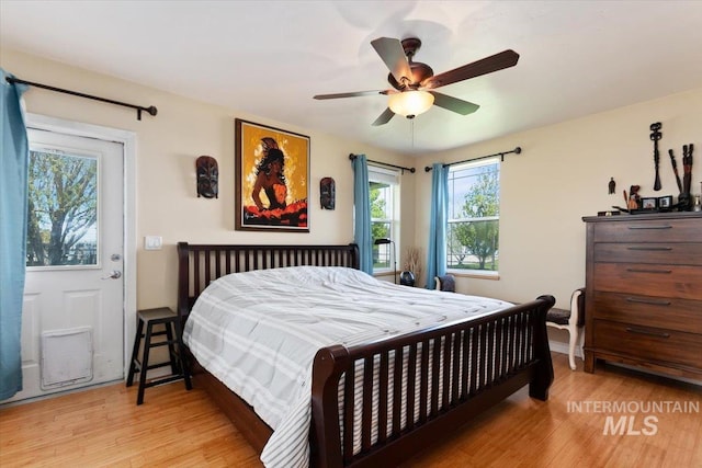 bedroom with light hardwood / wood-style floors and ceiling fan