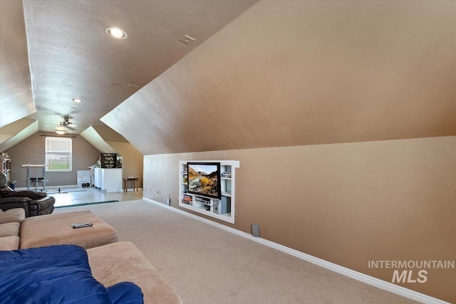 carpeted living room featuring ceiling fan and lofted ceiling