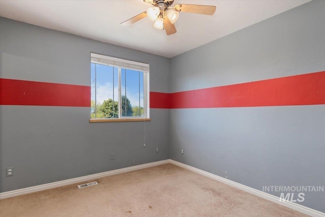 unfurnished room with carpet and ceiling fan