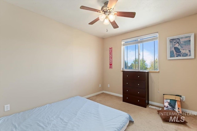 bedroom featuring light carpet and ceiling fan