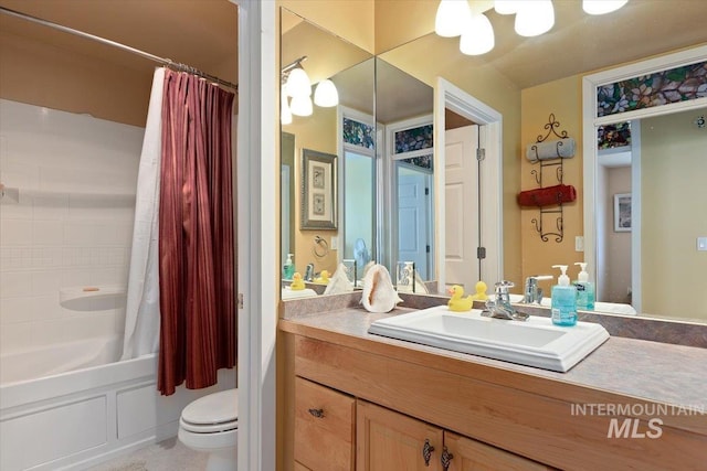 full bathroom featuring shower / bath combo, vanity, and toilet