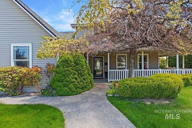 view of exterior entry with a porch