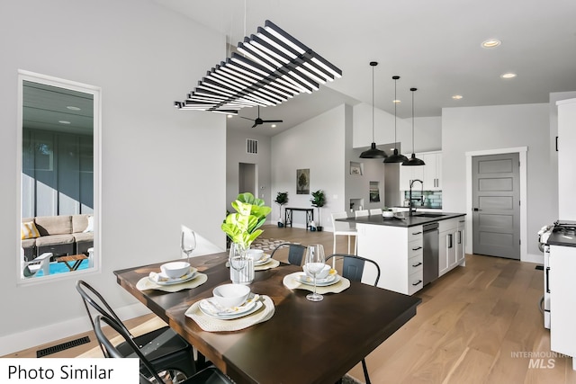 dining space with visible vents, recessed lighting, high vaulted ceiling, and light wood-type flooring