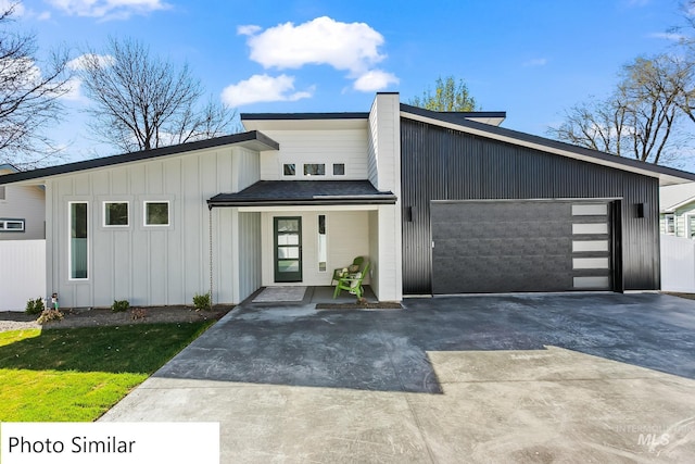 view of front facade with a garage, board and batten siding, and concrete driveway