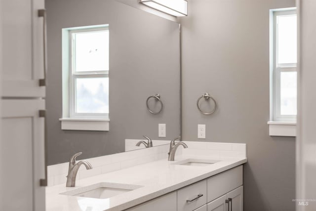 bathroom with double vanity and a sink