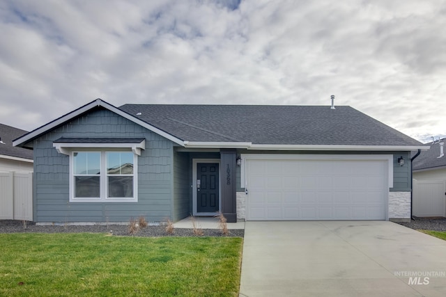 ranch-style home with roof with shingles, fence, a garage, driveway, and a front lawn