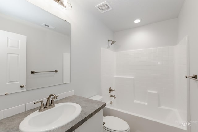 bathroom featuring visible vents, toilet, vanity, and bathtub / shower combination