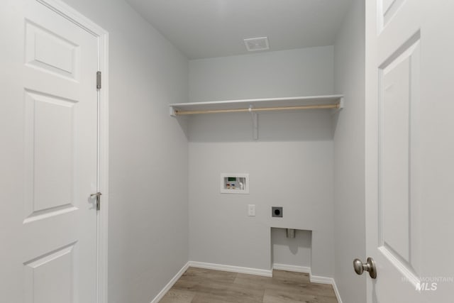 laundry room with visible vents, baseboards, laundry area, hookup for a washing machine, and electric dryer hookup
