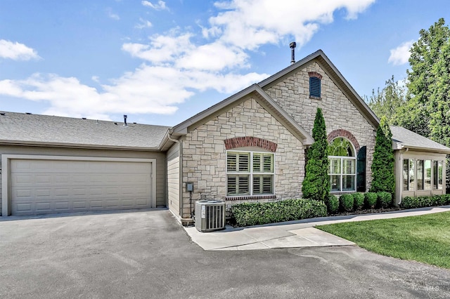 2814 N Cloverdale, Boise, ID 83713 - french country home featuring stone siding, an attached garage, and driveway