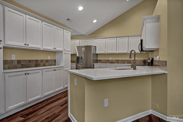2814 N Cloverdale, Boise, ID 83713 - kitchen featuring stainless steel fridge, a peninsula, tasteful backsplash, dark wood-style floors, and lofted ceiling