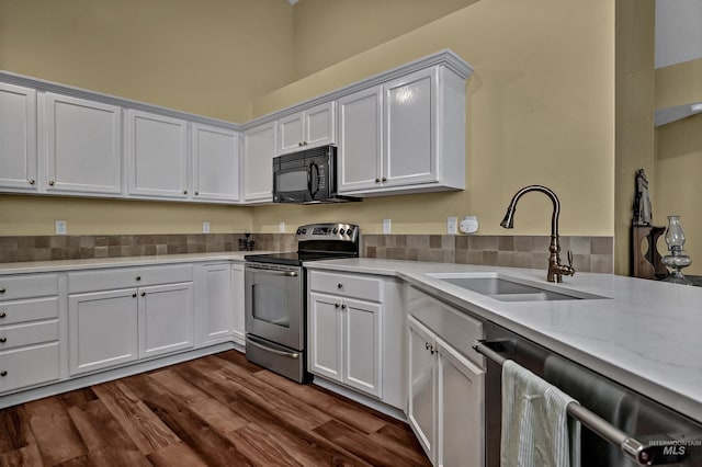 2814 N Cloverdale, Boise, ID 83713 - kitchen featuring appliances with stainless steel finishes, light countertops, dark wood finished floors, and white cabinets