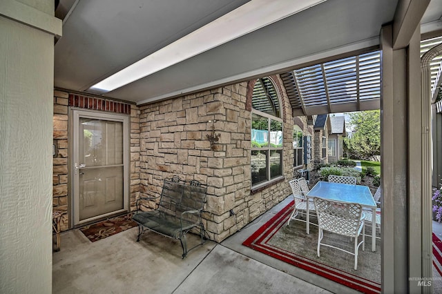 2814 N Cloverdale, Boise, ID 83713 - doorway to property featuring stone siding, outdoor dining area, and a patio