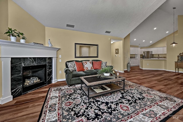 2814 N Cloverdale, Boise, ID 83713 - living room with wood finished floors, lofted ceiling, recessed lighting, and a high end fireplace