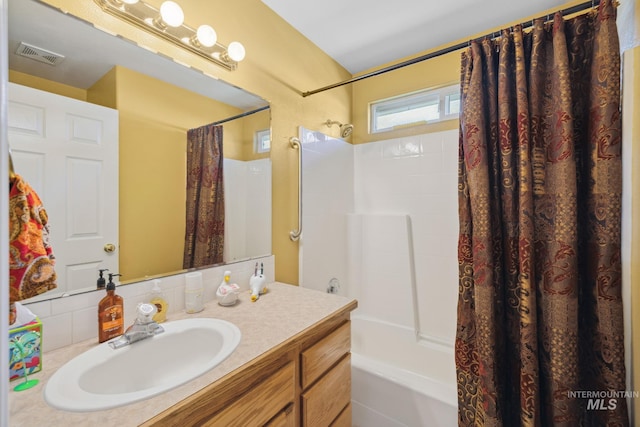 bathroom with vanity and shower / bath combo with shower curtain