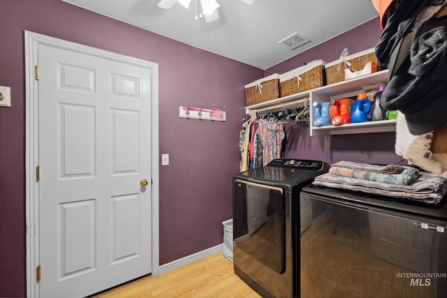 laundry room featuring ceiling fan, light wood-type flooring, and washing machine and clothes dryer