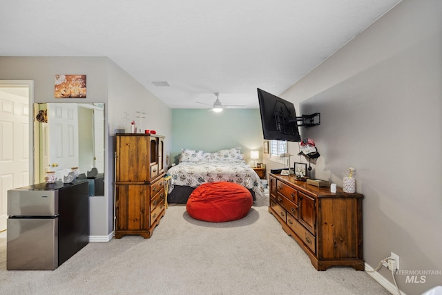 bedroom with light carpet, stainless steel refrigerator, ceiling fan, and lofted ceiling