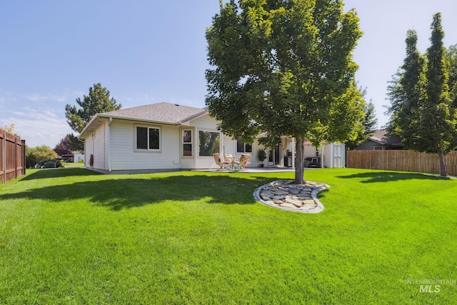 rear view of property with a yard and a patio