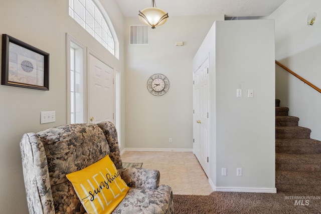 tiled entrance foyer with a towering ceiling