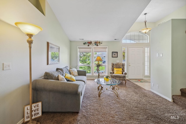 carpeted living room featuring vaulted ceiling