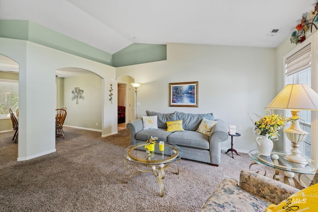 carpeted living room featuring vaulted ceiling