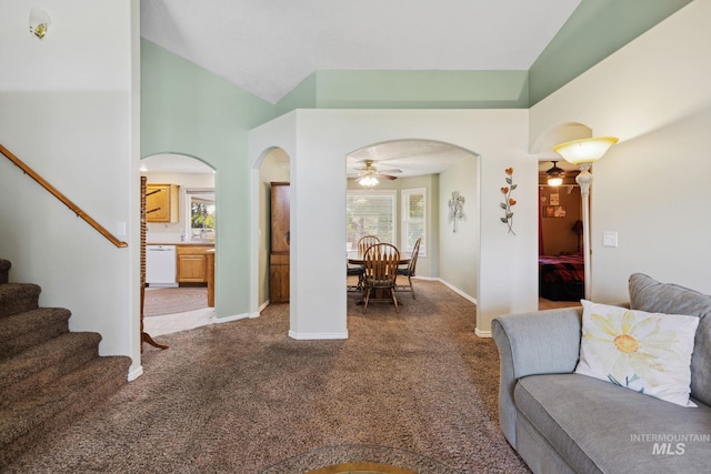 carpeted living room featuring ceiling fan and lofted ceiling