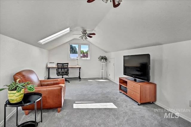 2942 E Eastgate Dr, Boise, ID 83716 - living room featuring a ceiling fan, a skylight, vaulted ceiling, carpet, and baseboards