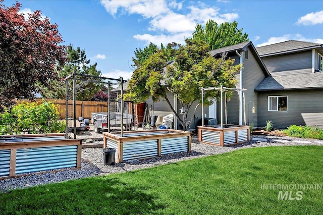 2942 E Eastgate Dr, Boise, ID 83716 - back of property featuring a garden and roof with shingles